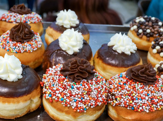 Fresh donuts on bakery display for Hanukkah celebration. Selective focus.