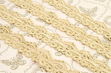 Ivory lace on vintage cream-coloured background 