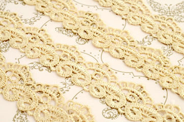 Ivory lace on vintage cream-coloured background 