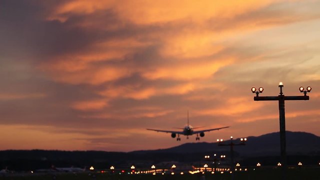 Airplane landing at Airport at sunset