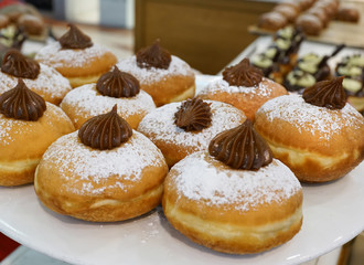 Close up of fresh donuts on bakery display for Hanuka celebration. Selective focus.