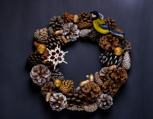 Christmas wreath of cones and toys made of wool