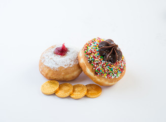 Fresh donuts, chocolate coins and silver dreidel for Hanukkah celebration. 