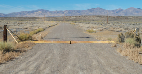 Cattle guard on a dirt road on range land in the Nevada desert