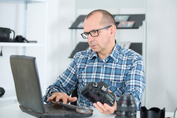 technician examining and repairing dslr camera