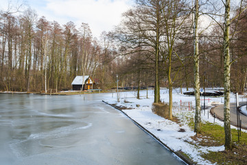 Springtime european park with frozen channel