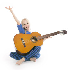 young happy blond girl in blue with guitar