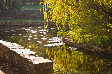 Autumn morning sun reflections on a small lake surface in Topcider park, Belgrade, Serbia