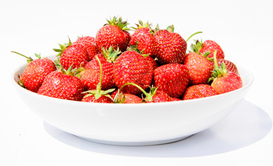 delicious, so sweet and juicy strawberries on a white plate