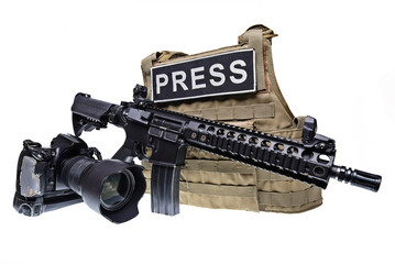 Body armor,digital camera and rifle isolated/Bulletproof vest for journalist,assault rifle and digital camera isolated on white background.Selective focus