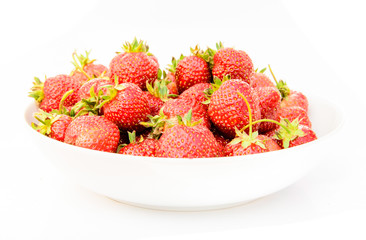 delicious, so sweet and juicy strawberries on a white plate