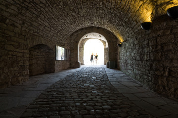 Dark stone streets  in an old town  and people