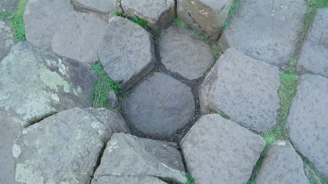 The rock formations from the Giants Causeway. The Giants Causeway is an area of about 40000 interlocking basalt columns the result of an ancient volcanic eruption.  in Ireland