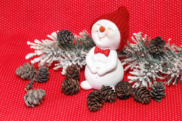 Happy New Year. Festive composition with snowman and pine cones