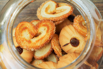 Open glass jar full of cookies. Top view.