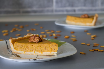 Two slices traditional pumpkin pie decoration halves of walnut