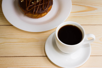 Cup of coffee with chocolate donuts
