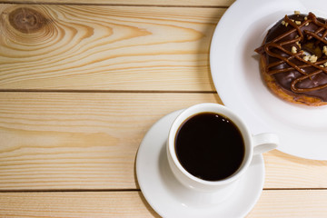 Cup of coffee with chocolate donuts
