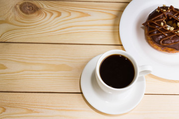 Cup of coffee with chocolate donuts