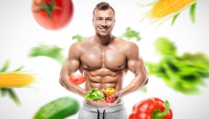 Shaped and healthy bodybuilder holding a fresh vegetables, flyin