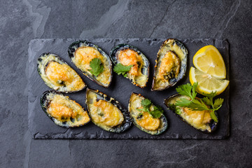 Seafood. Baked mussels with cheese and lemon in shells