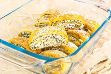 Puff buns with cottage cheese and poppy seeds in a glass baking 