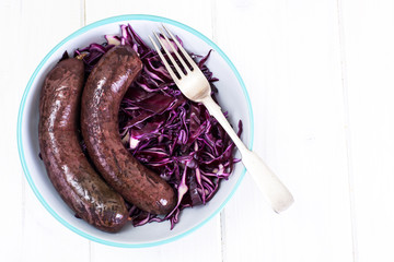 Blood sausage with garnish on old wooden table