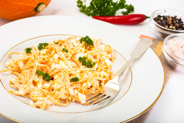 Pumpkin salad with egg, garlic and mayonnaise on a white plate