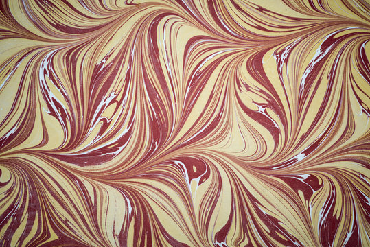 Ebru art. Traditional Turkish Ebru technique. Painting on water, followed by paper prints. Color paint ebru with waves and tile pattern.