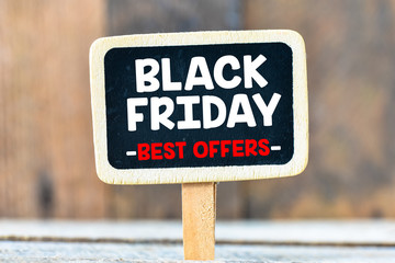 Fototapeta premium Black Friday handwritten with white chalk on a blackboard on a wooden background