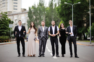 The company of friends walking through the city © Lelya