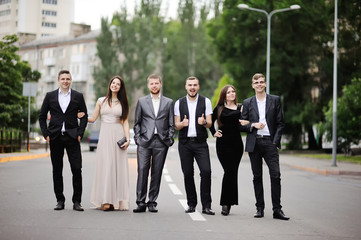 The company of friends walking through the city © Lelya