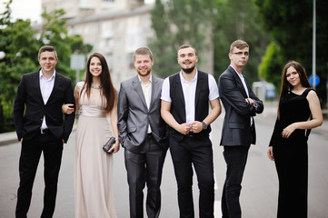 The company of friends walking through the city © Lelya