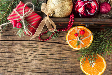 Christmas toy and tangerine on a wooden background
