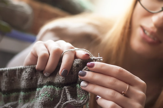 Woman hands knitting colorful wool yarn norway pattern. Close-up horizontal photo. Freelance creative working and living concept