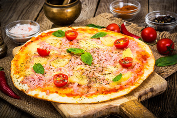 Hawaiian Pizza on a Thin Pastry with Ham, Meat and Pineapple. St