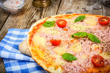 Hawaiian Pizza on a Thin Pastry with Ham, Meat and Pineapple. St