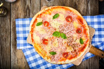 Hawaiian Pizza on a Thin Pastry with Ham, Meat and Pineapple. St