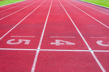 Numbers starting point on red running track,running track and green grass,Direct athletics Running track at Sport Stadium
