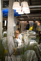 Pretty, young woman choosing the right furniture 