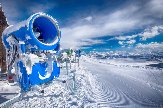 Snow cannons with fresh prepared ski slopes with the corduroy pattern in Kitzb&uuml;hel ski resort