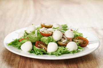 salad with kumato tomato, mozzarella, frillies lettuce and grated parmesan