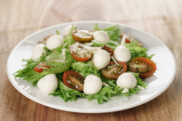 salad with kumato tomato, mozzarella, frillies lettuce and grated parmesan