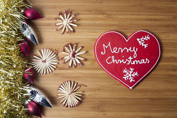 Christmas heart shaped decoration on wooden background