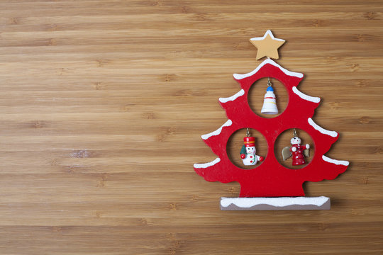 Christmas tree shaped decoration on wooden background with plent