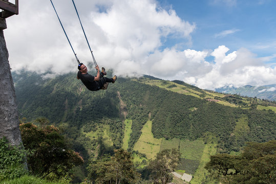 Man swings at Casa del Arbol, swing and treehouse vis-a-vis volcan Tungurahua