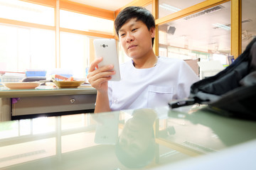 Portrait Young Asian woman using smartphone in office