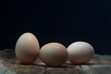 Eggs on wood background blue.