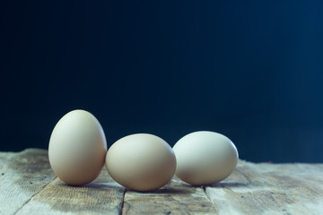 Eggs on wood background blue.