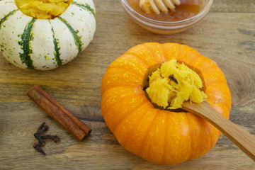 Breakfast stuffed mini pumpkins with honey and decorated with cinnamon and cloves 